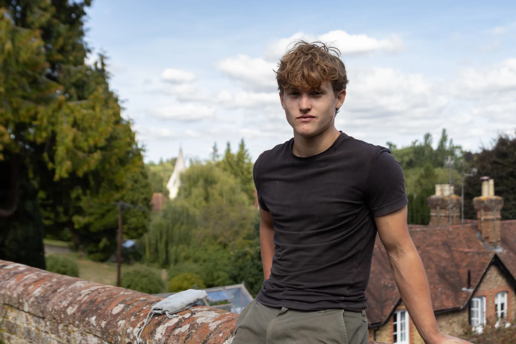 Austin sitting on a garden wall above Loose